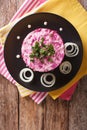 Russian food: holiday herring salad with vegetables closeup. Vertical top view Royalty Free Stock Photo