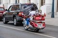 Russian football fan on a motorcycle `Honda Gold Wing` with the toy Zabivaka on the back rides on Varvarka street in the days of t