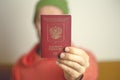 A Russian foreign international passport in the hands of a young Russian citizen. Russian citizenship, passport and rights concept Royalty Free Stock Photo