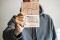 Russian foreign passport in the hands of a man. Prohibition of Schengen visas for Russian tourists to travel to the Royalty Free Stock Photo