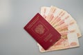 Russian foreign passport lies on a fan of 5000 Russian rubles currencies