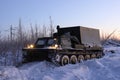 Russian GAZ-71 tracked all-terrain vehicle on a winter evening in Northern Siberia