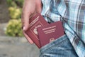 Russian and German passports in the hand in the pocket Royalty Free Stock Photo