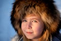 Russian girl with fur hat. Blue eyes.