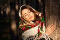 Russian girl in headscarves near the tree in the forest Royalty Free Stock Photo