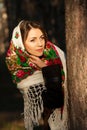 Russian girl in headscarves near the tree in the forest Royalty Free Stock Photo