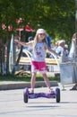 The Russian girl rides a giroskuter in the summer on the square. Royalty Free Stock Photo