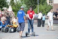 The Russian girl rides a giroskuter in the summer on the square. Royalty Free Stock Photo