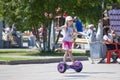 The Russian girl rides a giroskuter in the summer on the square. Royalty Free Stock Photo