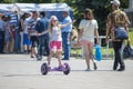 The Russian girl rides a giroskuter in the summer on the square. Royalty Free Stock Photo