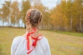 Russian girl Slavic appearance with braids with red ribbons in t