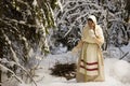 Russian girl with a sled in the winter woods Royalty Free Stock Photo