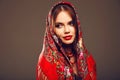 Russian girl style. Fashion woman portrait with traditional red headscarf. Beauty girl model with red lips makeup  on Royalty Free Stock Photo