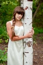 Russian girl in white dress in a birch forest Royalty Free Stock Photo