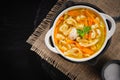 Russian homemade chicken soup with noodles and vegetables in a white plate on a black background Royalty Free Stock Photo