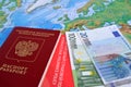 The Russian international passport, euro and the international insurance policy lie on a map