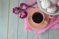 Russian marshmallowor zefir with pink cup of coffee on light teal wooden table. Top view, vintage style, dry roses. Empty place Royalty Free Stock Photo