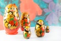 Russian matryoshkas on a light background and a colored background.