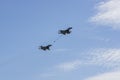 Russian MiG-29 multirole fighter jet and NATO-Fulcrum MiG-35 fighter jet demonstrate aerial refueling over airfield Royalty Free Stock Photo