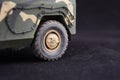 Russian military armored camouflage jeep Tiger. Closeup view. Plastic scale model on dark background Royalty Free Stock Photo