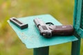 Russian 9mm handgun PM Makarov on the table with holster, belt and empty pistol holder