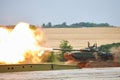 Russian modern tank T-72 shoots jumping over an obstacle