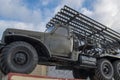 Russian multiple rocket launcher artillery BM-13 `Katyusha` mounted on soviet military truck on background of fence and cloudy sky