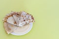 Russian national dish, pancakes with condensed milk on a white plate on a yellow background. Copy space Traditional