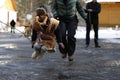 Russian national holiday Maslyanitsa. The boy jumps over the rope