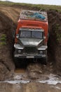 Russian off-road extreme expedition truck Ural driving on impassable dirty muddy mountain road in direction popular