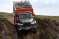 Russian off-road extreme expedition truck Ural driving on mountain road, transportation travelers in direction travel destinations