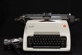 Russian old Zenit E film camera and vintage white Olympia Arabic typewriter.