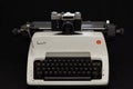 Russian old Zenit E film camera on vintage white Olympia Arabic typewriter. Royalty Free Stock Photo