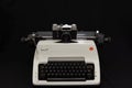Russian old Zenit E film camera on vintage white Olympia Arabic typewriter.