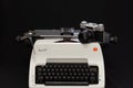 Russian old Zenit E film camera on vintage white Olympia Arabic typewriter.