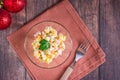 Russian olivier salad of sausage and boiled vegetables in bowls on a wooden table. Top view. Closeup Royalty Free Stock Photo