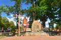 Russian orthodox church with stone monument and cross