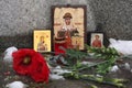 Russian orthodox icons and poppy flowers at a cemetery.