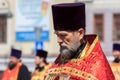 Russian Orthodox priest holding a Bible during a procession on Easter