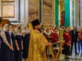 Russian Orthodox priest in traditional clothing serving in the Saint Isaac`s Russian Orthodox Cathedral in Saint Petersburg Russi