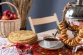 Russian pancakes blini with samovar tea cup and drying on the table