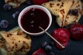 Russian pancakes with jam, black currant and strawberries Royalty Free Stock Photo