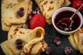 Russian pancakes with jam, black currant and strawberries Royalty Free Stock Photo
