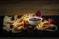 Russian pancakes with jam, black currant and strawberries Royalty Free Stock Photo