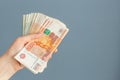 Russian, paper banknotes in their hands on a blue background Royalty Free Stock Photo