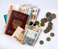 Russian paper money and ruble coins, as well as plastic cards and the passport of the Russian Federation on a white background. Royalty Free Stock Photo