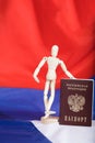 Russian pass and wooden dummy figurine on Russian flag. Royalty Free Stock Photo