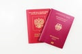 Russian passport behind German passport isolated on white background Royalty Free Stock Photo