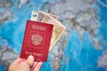 Russian passport and Euro banknotes on the map background Royalty Free Stock Photo
