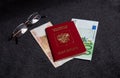 Russian passport, euros, rubles and glasses. Currency exchange. Dark background Royalty Free Stock Photo